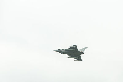 Low angle view of airplane flying against sky