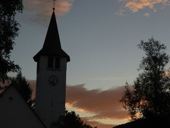 Low angle view of bell tower against sky