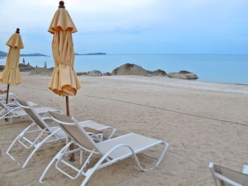 Bed beach and yellow umbrella on tropical beach in the summer morning. nature and travel concept.