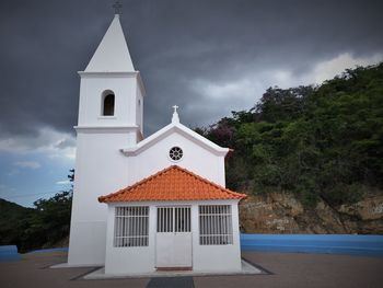 View of bell tower against cloudy sky