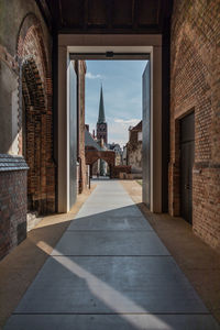 Corridor of historic building against sky