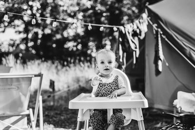 Portrait of young woman sitting on table