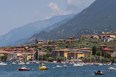 High angle view of townscape by mountains against sky