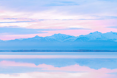 Scenic view of snowcapped mountains against sky during sunset