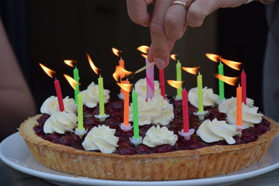 Close-up of hand holding cake