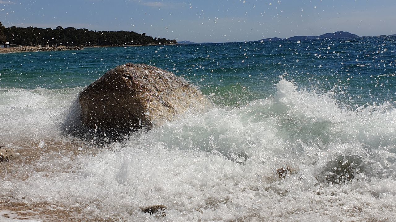 SEA WAVES SPLASHING ON ROCK