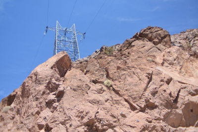 Low angle view of sailboat on mountain against sky