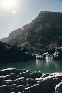 Scenic view of lake and mountains against sky