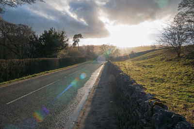 Empty road along countryside landscape