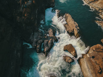 High angle view of rocks in sea