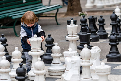 Full frame shot of boy playing on chess board