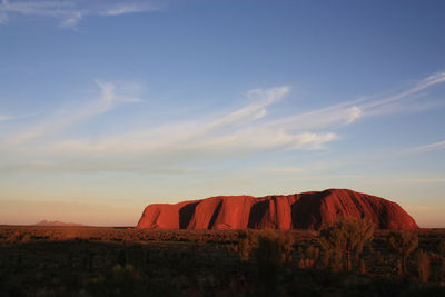 Scenic view of rock formation against sky during sunset australia - ayers rock