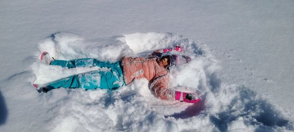 Low section of person  playing on snow covered field