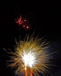 Low angle view of firework display at night
