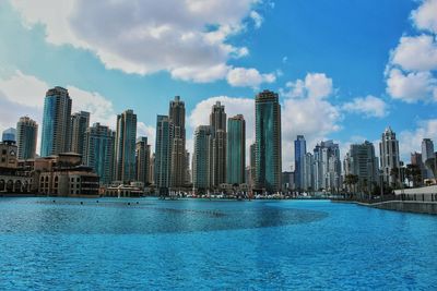 Panoramic view of city by sea against sky