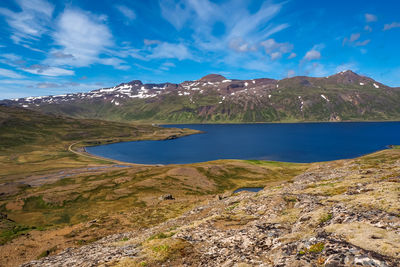 View over a fjord from above djupavik in the westfjords of iceland with a dramatic blue sky