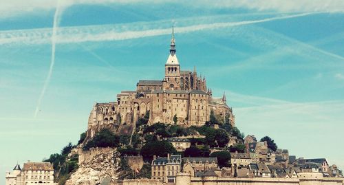 Low angle view of mont saint-michel against sky
