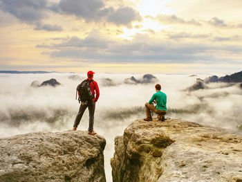 Two friends, hiker and photo enthusiast take photos of fall landscape. well dressed hikers in nature