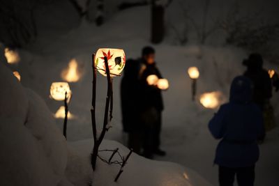 Low angle view of illuminated street light during winter