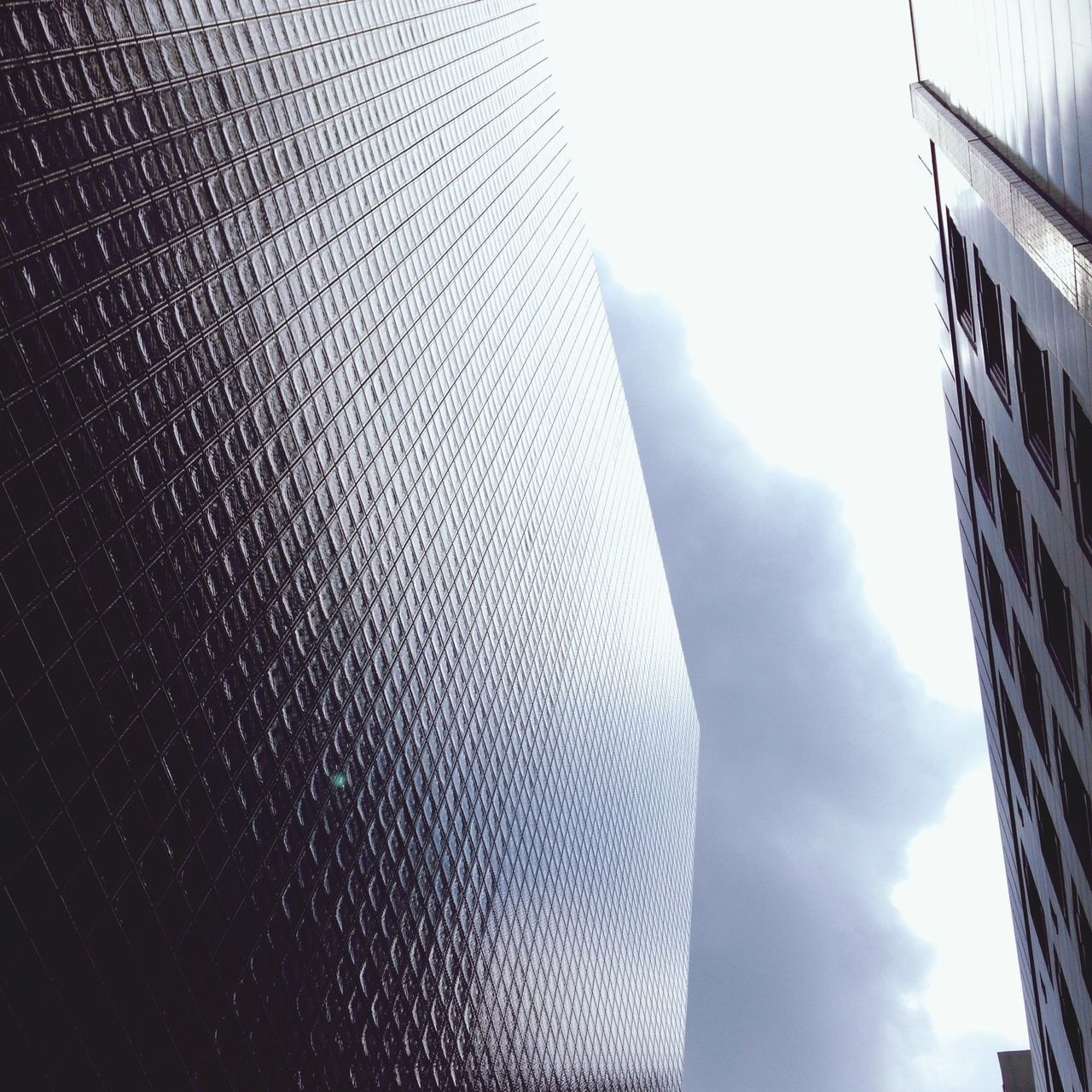 sky, building exterior, architecture, low angle view, built structure, window, day, glass - material, part of, city, outdoors, close-up, building, no people, cloud - sky, cropped, weather, cloud, modern, office building