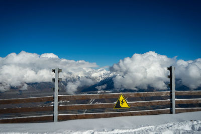 Scenic view of snowcapped mountains against blue sky