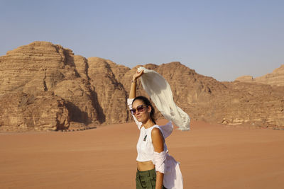 Rear view of woman standing against mountain