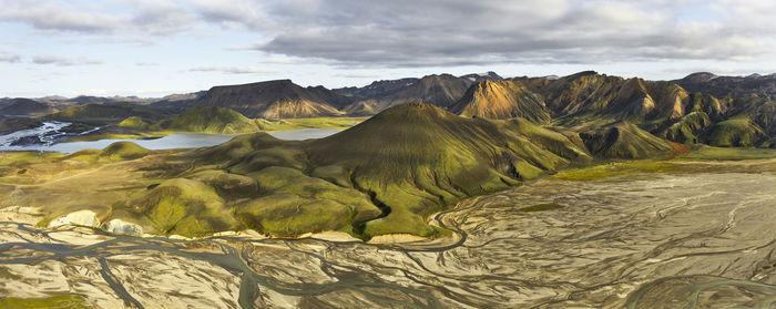 Dry riverbed and hills on cloudy day