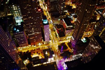 High angle view of city lit up at night