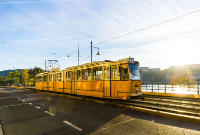 Cable car by road against sky