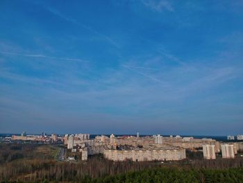 Buildings in city against blue sky