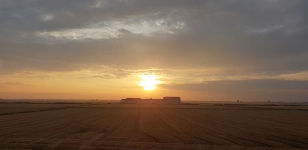 Scenic view of field against sky during sunset