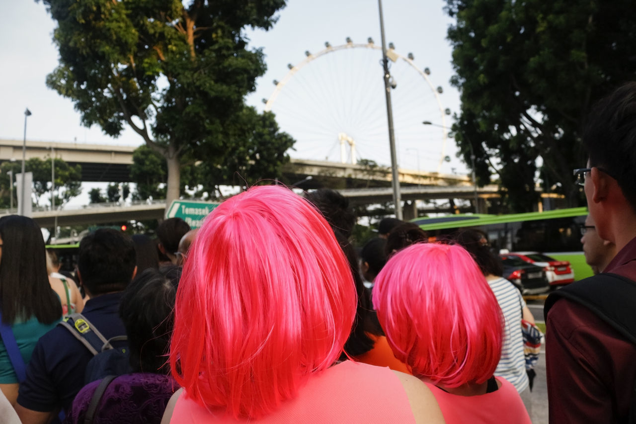 real people, celebration, women, lifestyles, rear view, men, outdoors, large group of people, leisure activity, day, tree, adults only, people, adult