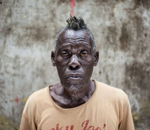 Close-up portrait of man against wall