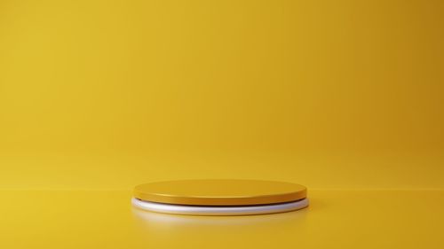 Close-up of yellow cup on table