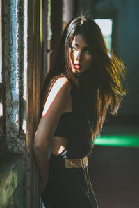 Beautiful young woman standing indoors