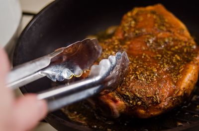 Cropped hand of person preparing food 