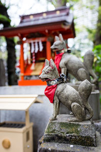 Statue by temple against building