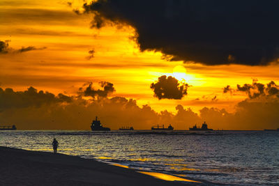 Scenic view of sea against orange sky