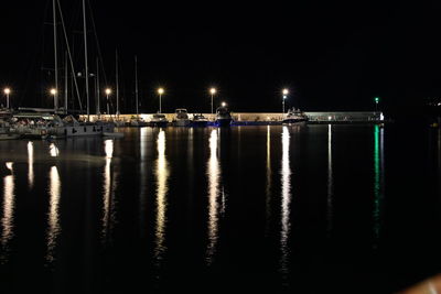 Sailboats in sea against sky at night