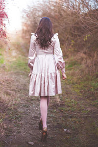 Rear view of young woman walking outdoors