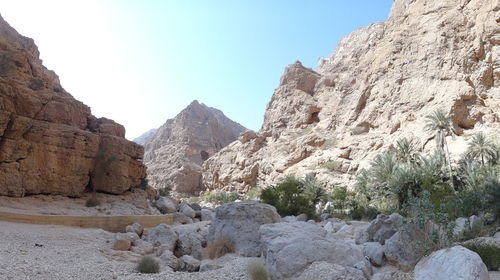 Rocks and mountains against clear sky