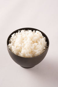 High angle view of food in bowl against white background