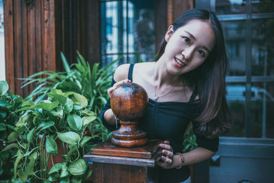 Portrait of smiling young woman standing outdoors