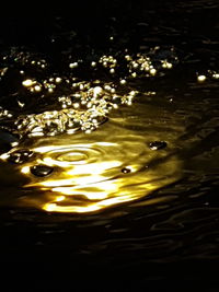 Close-up of water splashing in illuminated at night