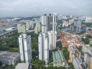 High angle view of modern buildings in city against sky