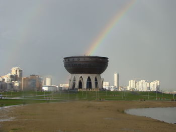 View of rainbow over buildings in city