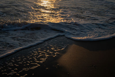 High angle view of surf on beach during sunset