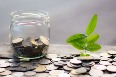 Close-up of coins in glass jar on table