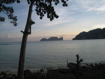 Scenic view of sea and mountains against sky