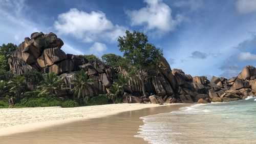 Scenic view of rocks on beach against sky